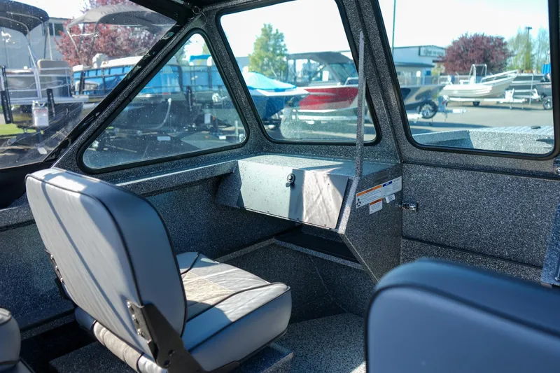 Slide: The Image of 2024 Alumaweld Talon 18 boat interior with seating and dashboard, showcasing modern design. - 14