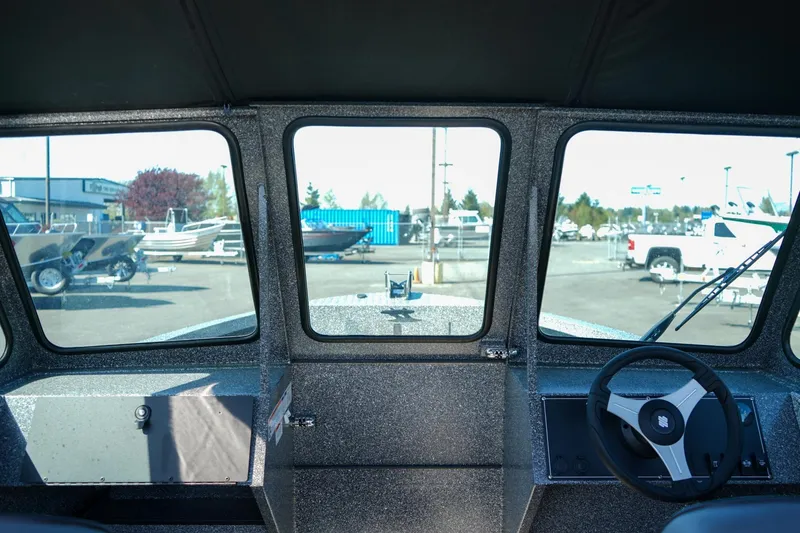 Slide: The Image of Interior view of 2024 Alumaweld Talon 18 boat, showcasing dashboard and steering wheel. - 16