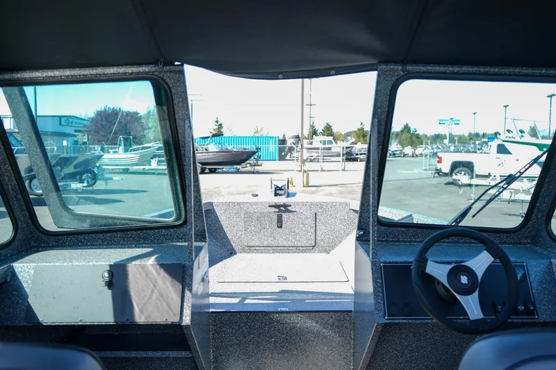 Slide: The Image of 2024 Alumaweld Talon 18 boat interior with steering wheel and dashboard view. - 17