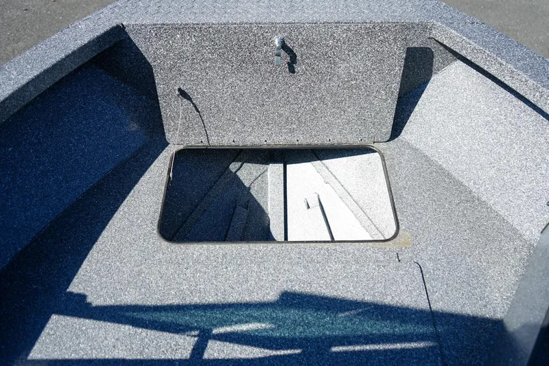 Slide: The Image of 2024 Alumaweld Talon 18 boat interior with open storage compartment. - 19