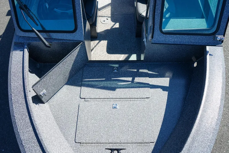 Slide: The Image of 2024 Alumaweld Talon 18 boat interior with storage compartments and seating area. - 21