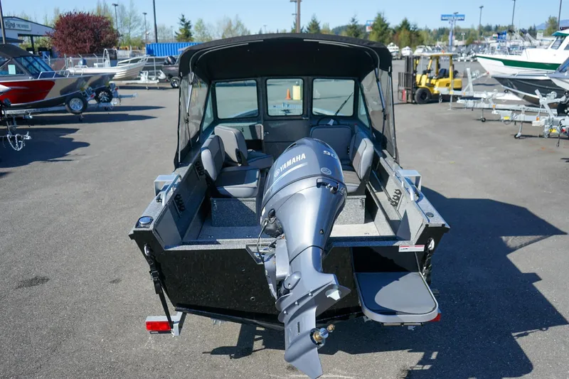 Slide: The Image of 2024 Alumaweld Talon 18 boat with Yamaha outboard motor, displayed in a marina setting. - 4