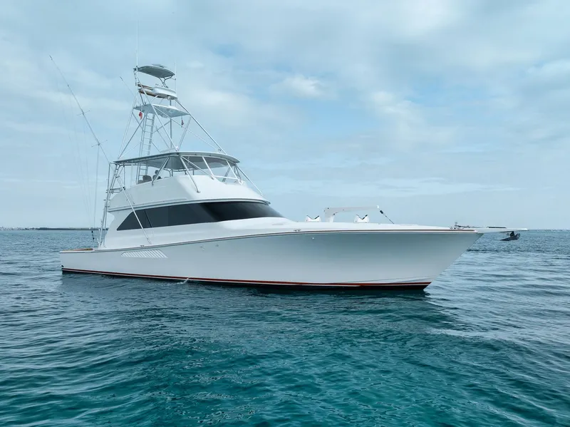 The Image of 2001 Viking 65 yacht on calm ocean waters under a cloudy sky. - 0