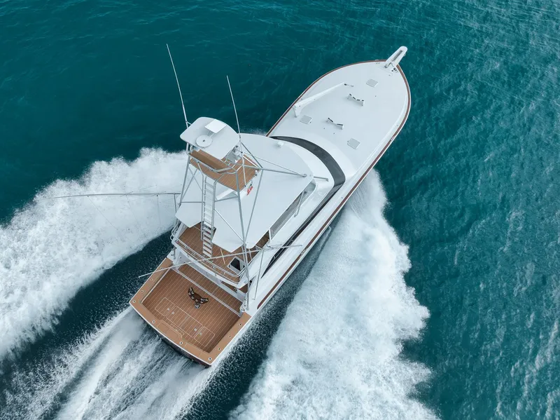 Slide: The Image of Aerial view of 2001 Viking 65 yacht cruising on blue ocean waters. - 10