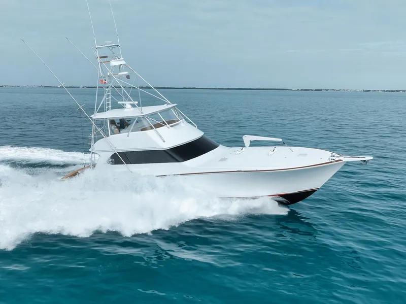 Slide: The Image of 2001 Viking 65 yacht cruising on open blue waters. - 11