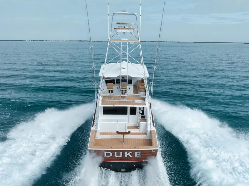 Slide: The Image of A 2001 Viking 65 yacht named "DUKE" cruising on open water. - 12