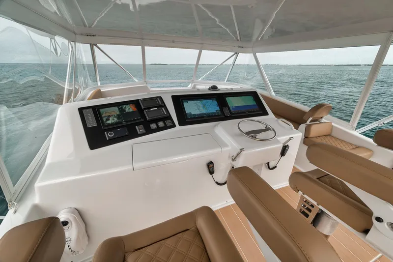 Slide: The Image of Helm of 2001 Viking 65 yacht with modern navigation equipment and ocean view. - 14