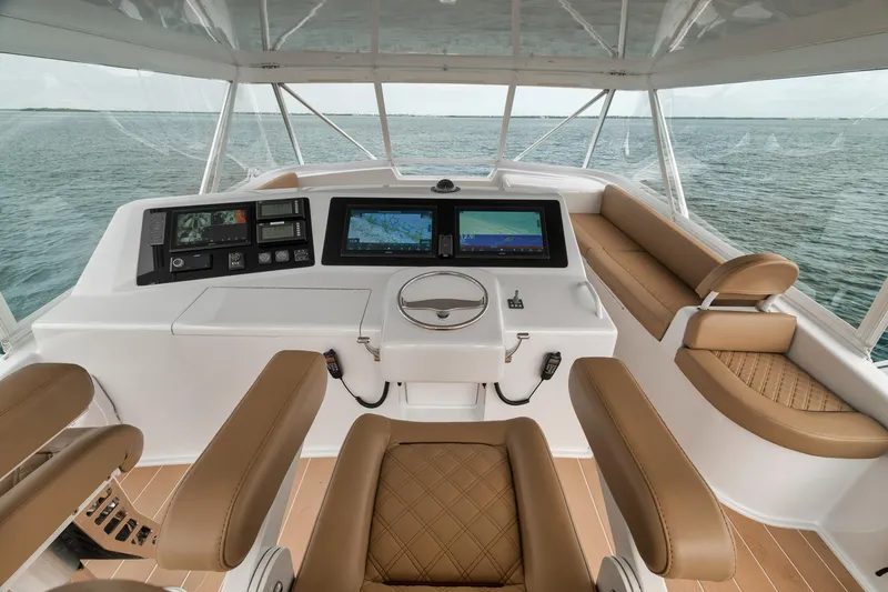 Slide: The Image of Helm of 2001 Viking 65 yacht with modern navigation systems and leather seating. - 15