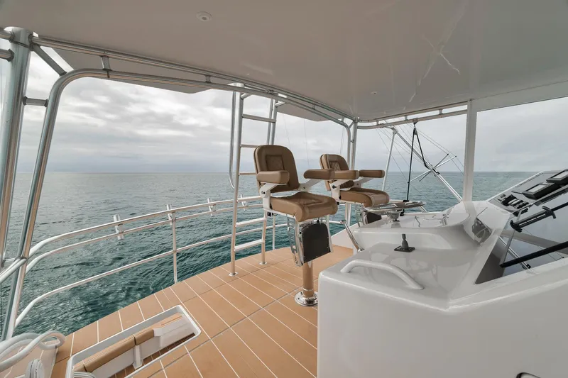 Slide: The Image of Flybridge of 2001 Viking 65 yacht with ocean view and helm chairs. - 19