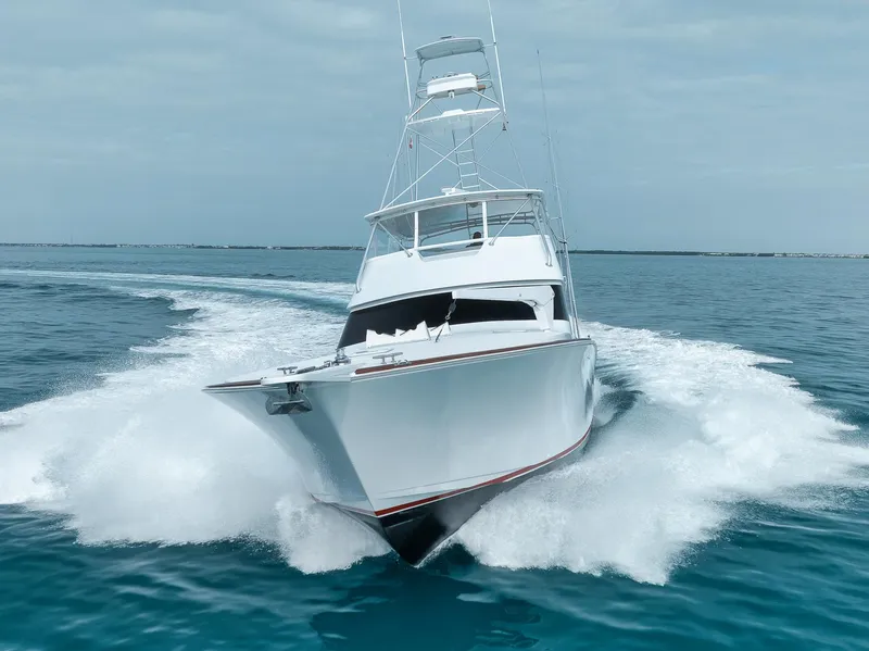 Slide: The Image of 2001 Viking 65 yacht cruising swiftly on open water. - 2