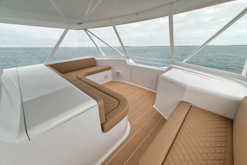 Slide: The Image of Luxurious interior of 2001 Viking 65 yacht with ocean view and tan seating. - 23