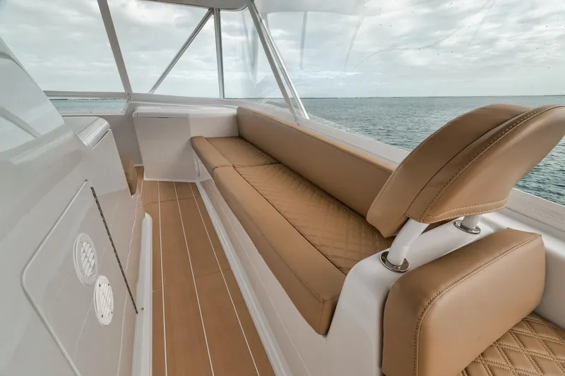 Slide: The Image of Luxurious interior of 2001 Viking 65 yacht with tan leather seating and ocean view. - 24