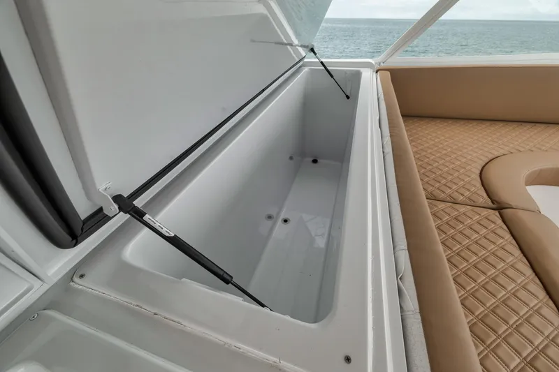 Slide: The Image of Open storage compartment on 2001 Viking 65 yacht, with cushioned seating and ocean view. - 26
