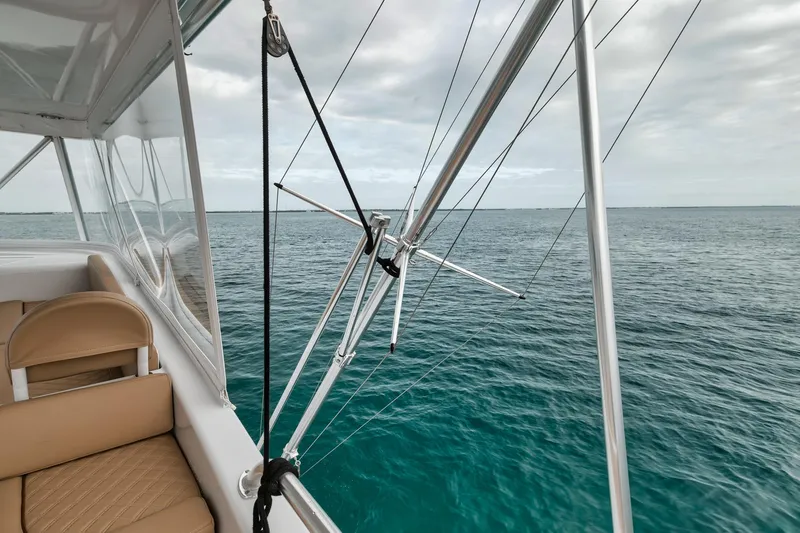 Slide: The Image of 2001 Viking 65 yacht with fishing outriggers on open sea. - 28