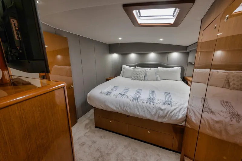Slide: The Image of Luxurious bedroom interior of 2001 Viking 65 yacht with cozy bedding and modern design. - 33