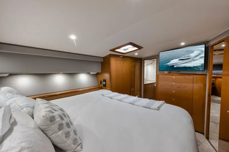 Slide: The Image of Luxurious bedroom interior of 2001 Viking 65 yacht with modern amenities and elegant design. - 34