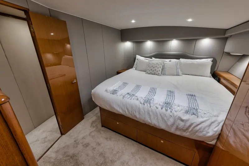 Slide: The Image of Luxurious bedroom interior of 2001 Viking 65 yacht with cozy bedding and modern lighting. - 35