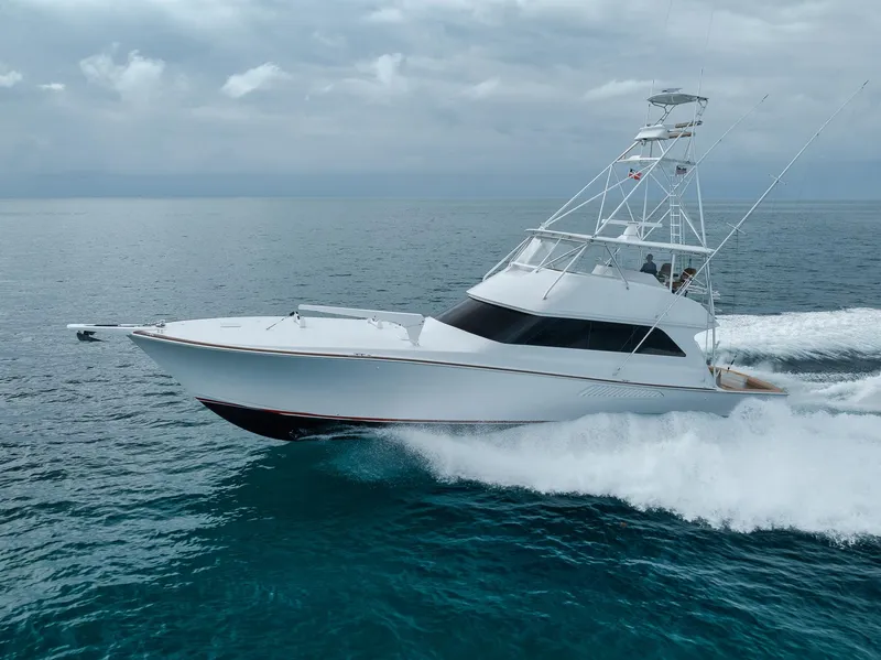 Slide: The Image of 2001 Viking 65 yacht cruising on open ocean under cloudy skies. - 4