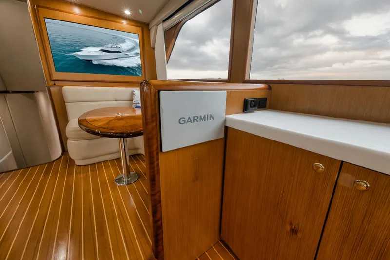 Slide: The Image of Luxurious interior of 2001 Viking 65 yacht with wood finish and Garmin equipment. - 43