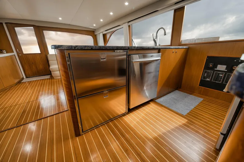 Slide: The Image of Luxurious 2001 Viking 65 yacht interior with modern kitchen and wooden flooring. - 45