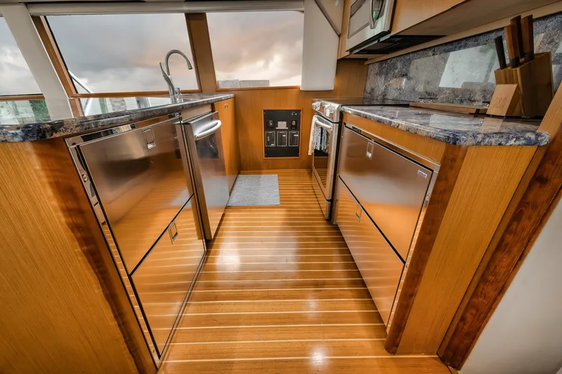 Slide: The Image of Luxurious kitchen interior of 2001 Viking 65 yacht with wooden flooring and modern appliances. - 46