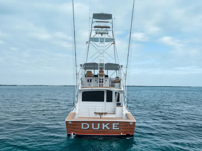 Slide: The Image of 2001 Viking 65 yacht named "DUKE" on calm ocean waters. - 6