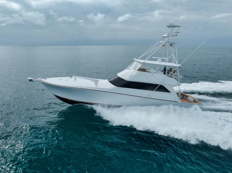 Slide: The Image of 2001 Viking 65 yacht cruising on open sea with white waves. - 9