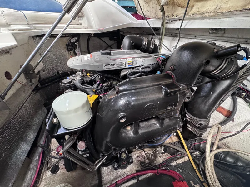 Slide: The Image of Engine compartment of a 2011 Crownline 245 SS boat, showcasing detailed mechanical components. - 14