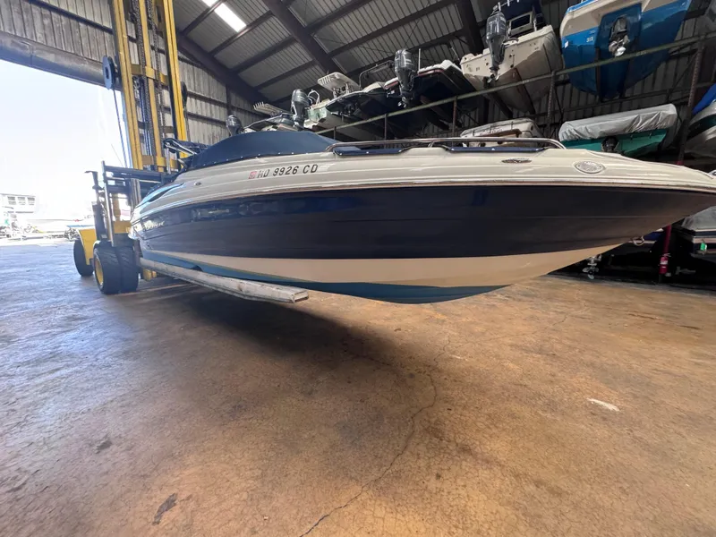 Slide: The Image of 2011 Crownline 245 SS boat in storage facility, elevated by forklift. - 3