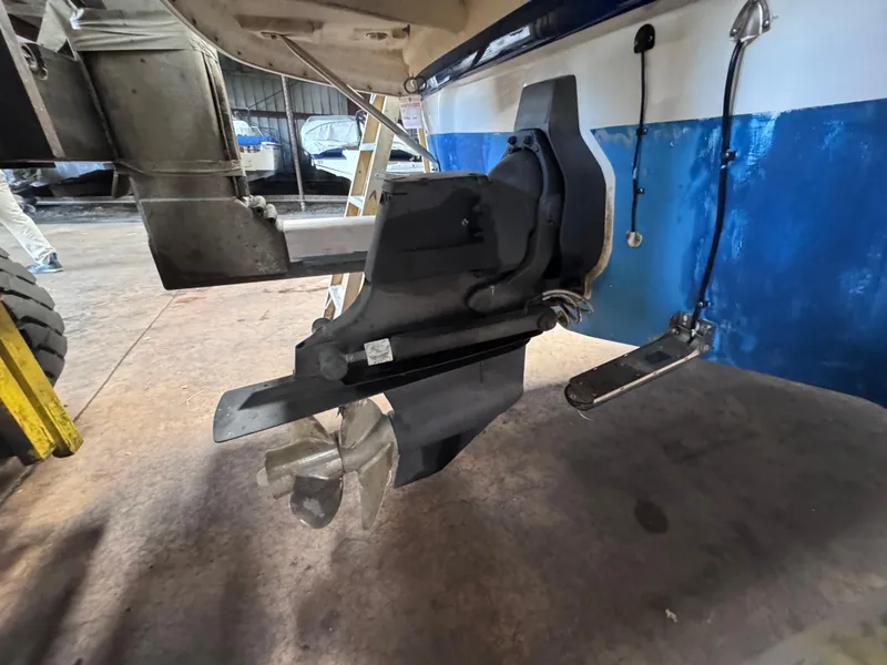 Slide: The Image of 2011 Crownline 245 SS boat stern drive and propeller in a garage setting. - 4