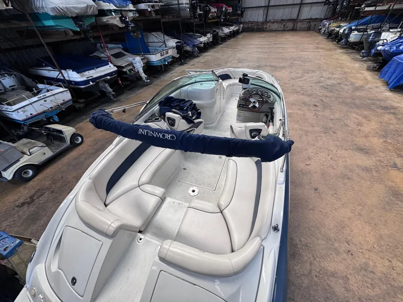 Slide: The Image of 2011 Crownline 245 SS boat in storage, featuring spacious seating and sleek design. - 6