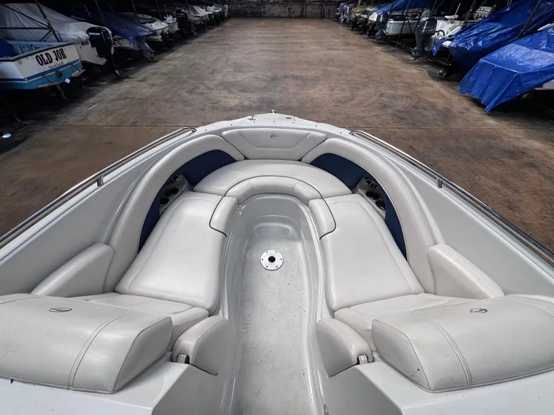 Slide: The Image of 2011 Crownline 245 SS boat interior with white seating in storage facility. - 8