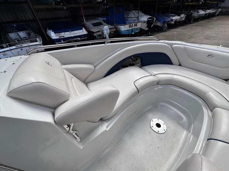Slide: The Image of 2011 Crownline 245 SS boat interior with white leather seating in storage facility. - 9