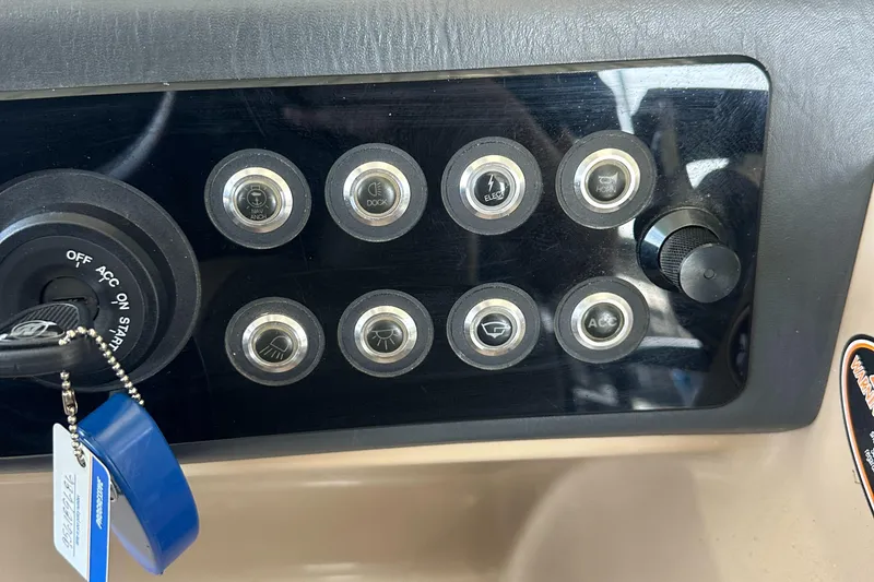 Slide: The Image of Control panel of 2019 Harris Solstice 240 boat with ignition switch and buttons. - 16