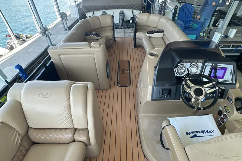 Slide: The Image of Luxurious 2019 Harris Solstice 240 boat interior with plush seating and modern dashboard. - 19