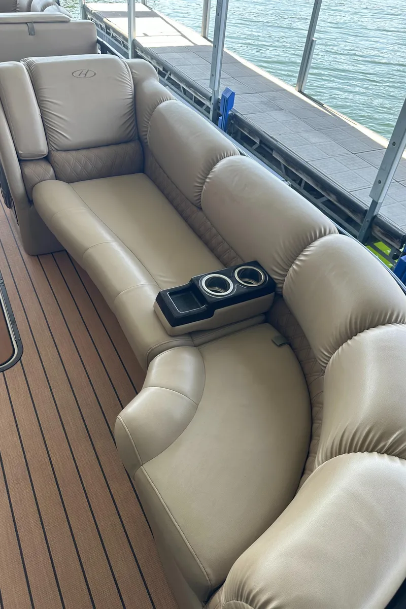 Slide: The Image of 2019 Harris Solstice 240 boat interior with plush beige seating and cup holders. - 23