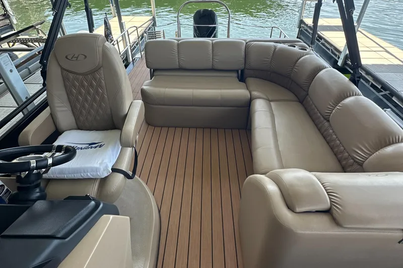 Slide: The Image of 2019 Harris Solstice 240 pontoon boat interior with beige seating and wood-style flooring. - 28