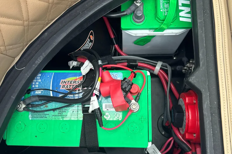 Slide: The Image of Battery compartment of a 2019 Harris Solstice 240 boat with wiring and connections. - 33