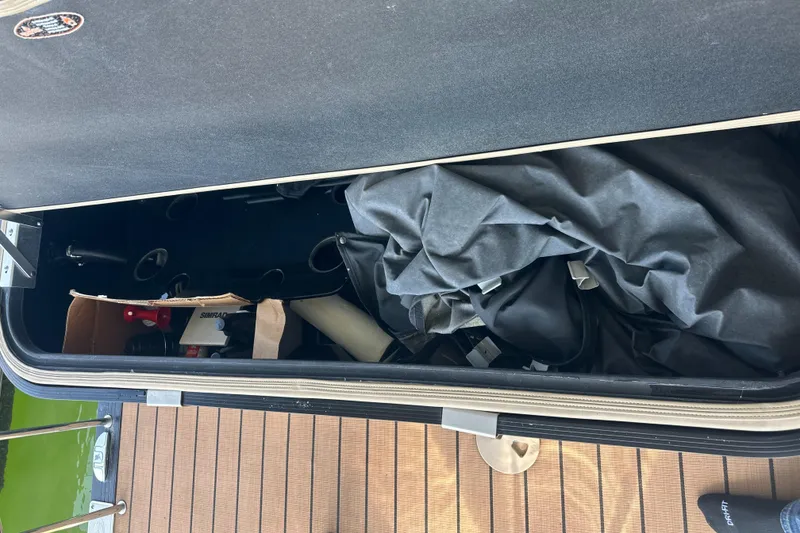 Slide: The Image of Storage compartment of a 2019 Harris Solstice 240 boat, containing various items and equipment. - 34
