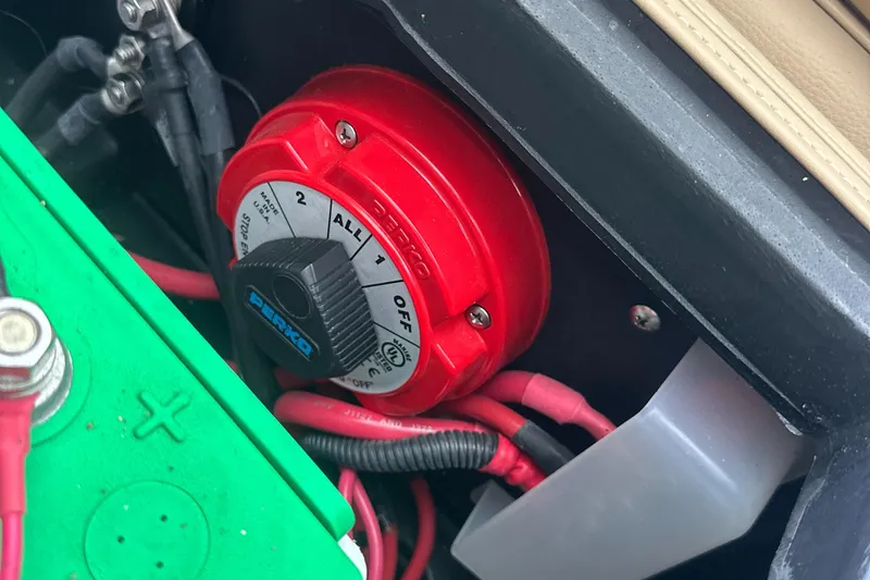 Slide: The Image of Battery switch in a 2019 Harris Solstice 240 boat, featuring red and black wiring. - 35