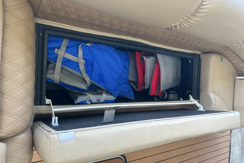 Slide: The Image of Storage compartment with life jackets in a 2019 Harris Solstice 240 boat. - 36