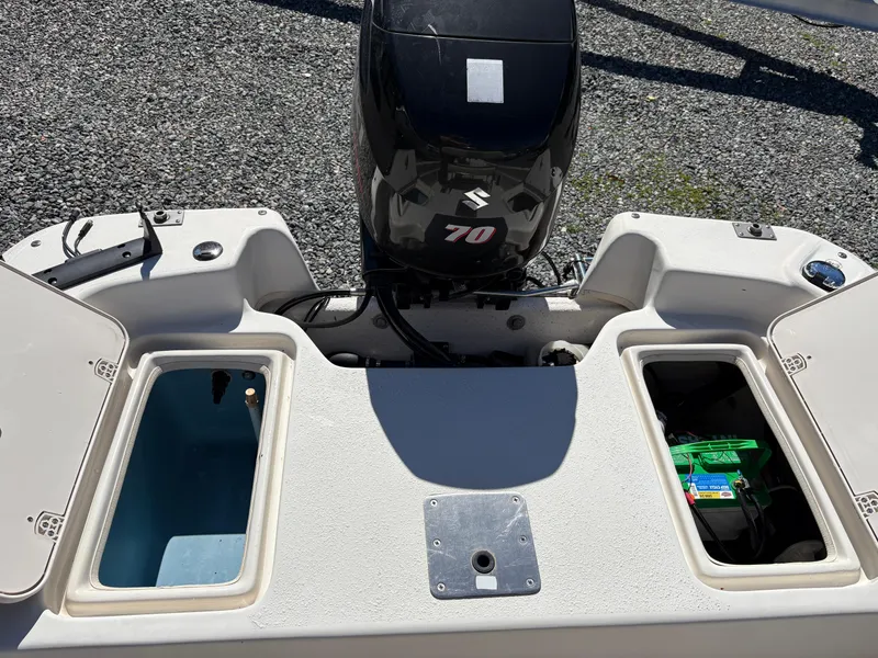 Slide: The Image of 2017 Carolina Skiff 18JVX boat with Suzuki 70 engine, open storage compartments. - 11