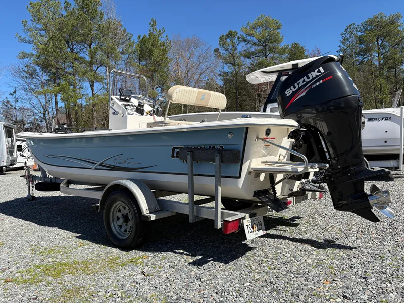 Slide: The Image of 2017 Carolina Skiff 18JVX boat with Suzuki outboard motor on a trailer. - 2