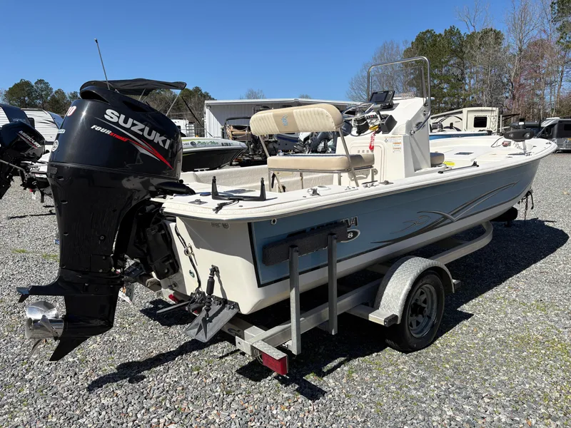 Slide: The Image of 2017 Carolina Skiff 18JVX boat with Suzuki outboard motor on a trailer. - 3