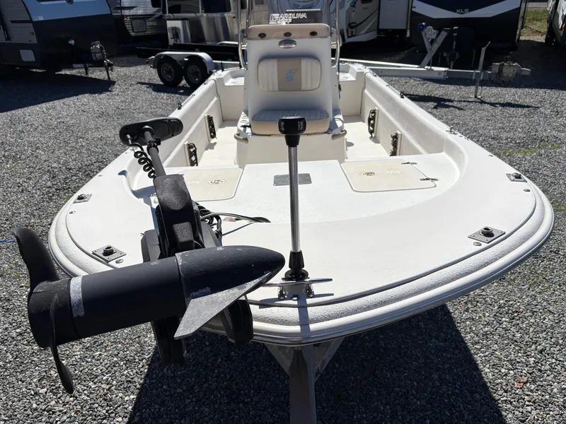Slide: The Image of 2017 Carolina Skiff 18JVX boat with trolling motor, parked on gravel lot. - 5