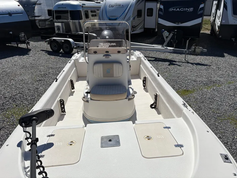 Slide: The Image of 2017 Carolina Skiff 18JVX boat with center console, parked among RVs. - 6