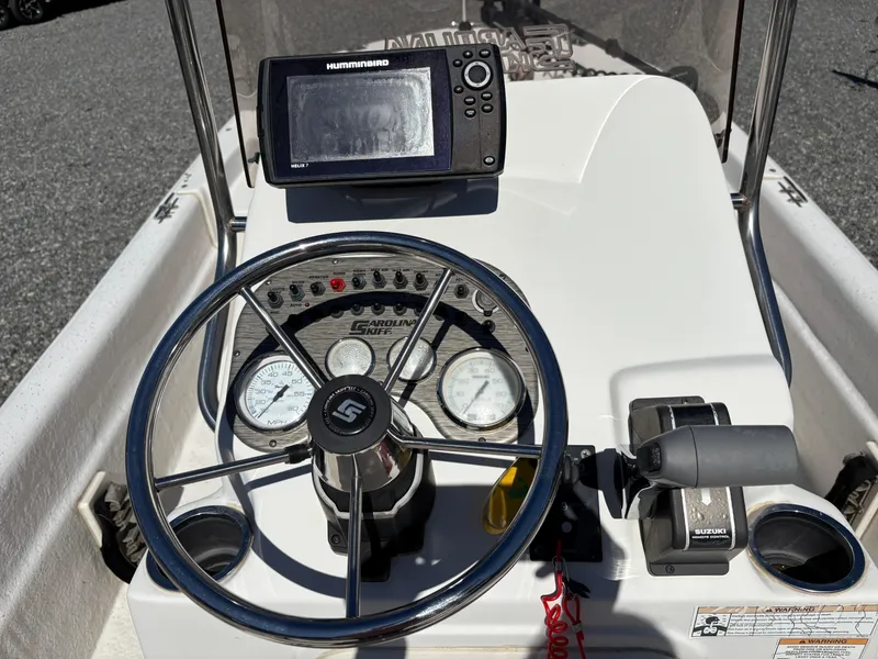 Slide: The Image of 2017 Carolina Skiff 18JVX boat dashboard with steering wheel and Humminbird GPS. - 8