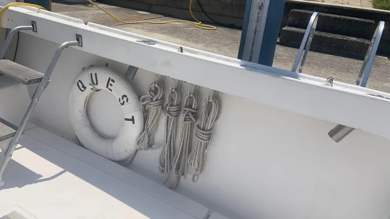 Slide: The Image of 1987 Luhrs Alura 30 boat deck with life preserver and ropes. - 10
