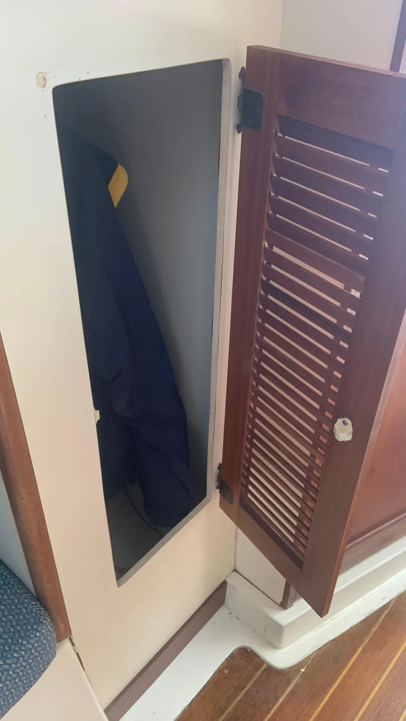 Slide: The Image of Open wooden cabinet door on 1987 Luhrs Alura 30 boat interior. - 15