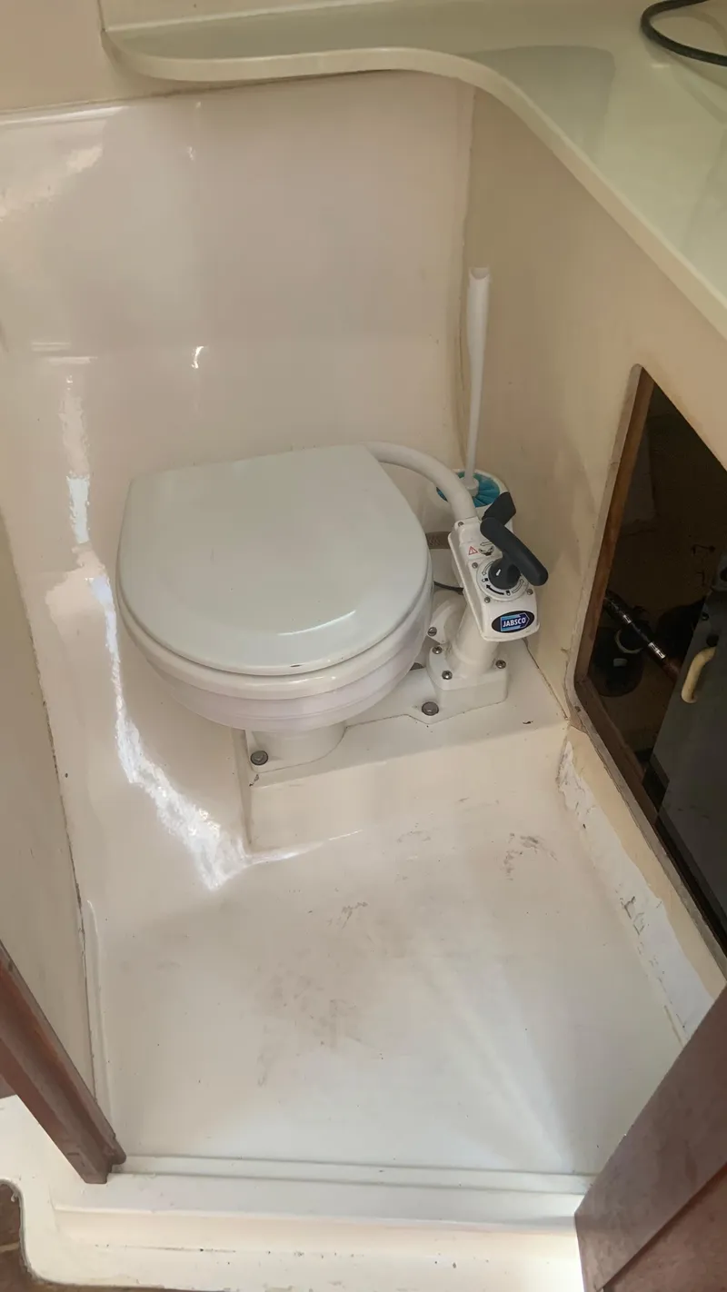 Slide: The Image of 1987 Luhrs Alura 30 boat bathroom with compact marine toilet. - 16